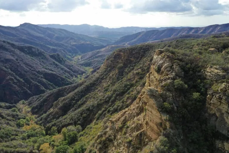 Scenic mountain landscape with lush green valleys and rugged cliffs.