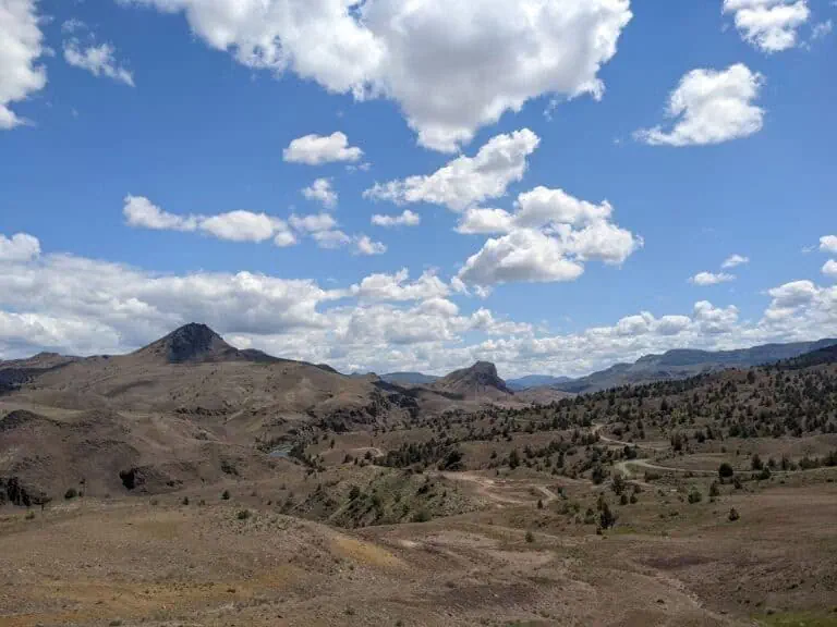 Scenic view of Enchanted Rocks with rolling hills and blue sky.