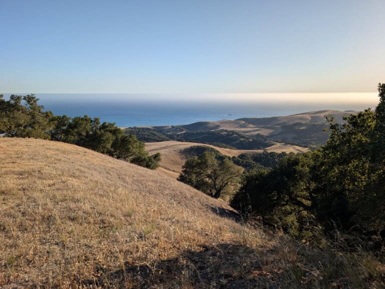 Beautiful landscape of Wild Cherry Canyon with rolling hills and ocean view.